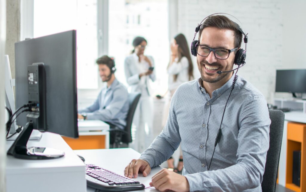 man smiling and laughing with voip headset on