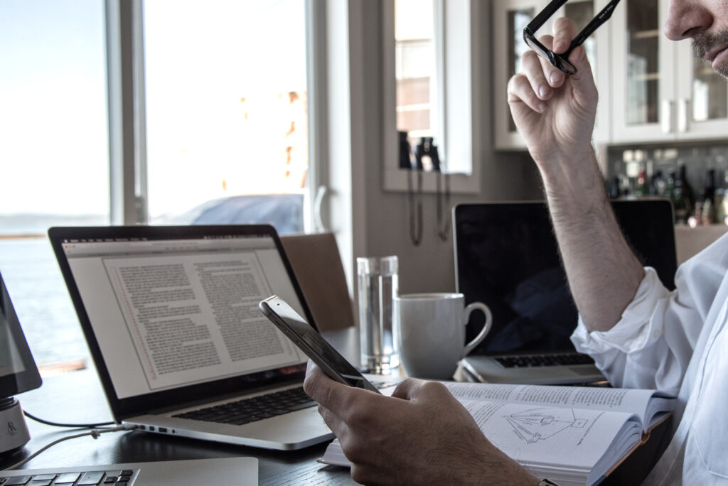 remote worker using computer and cellphone